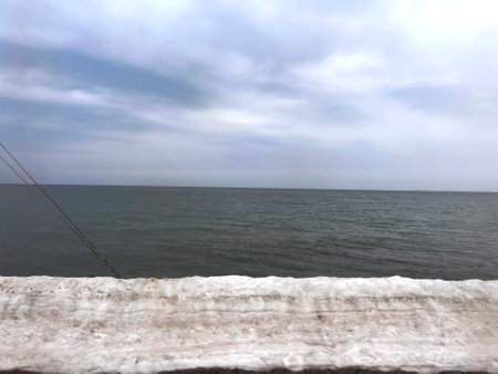 Sea view from the wooden pier on the background of the cloudy skyの写真素材