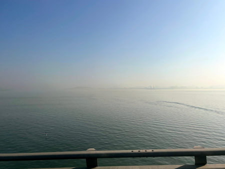 View of the sea from the pier in the early morning with fog