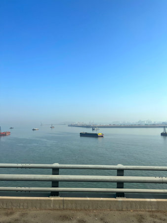 Tugboat and bulk carrier in the sea, closeup of photoの写真素材