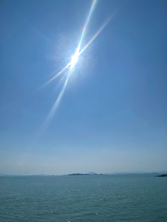 Sunbeam in the blue sky over the sea. Natural background.