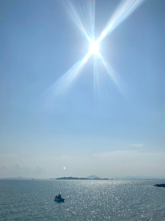 Sunrise in the sea with blue sky and sunbeam over the seaの写真素材