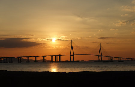 Sunset in the sea with a cable-stayed bridge.の写真素材