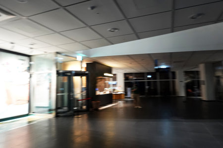 Blurred image of business people in the lobby of a modern office buildingの写真素材