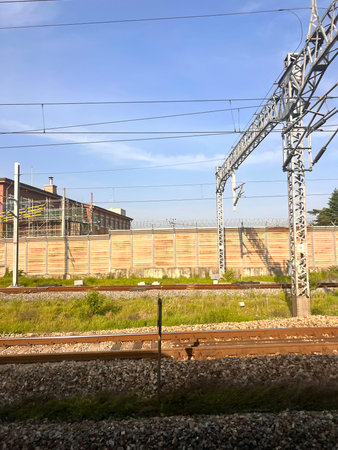 Railway station with high-voltage power lines and blue sky