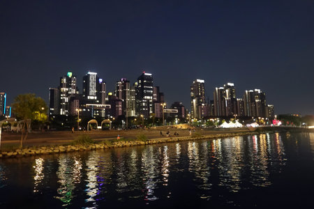 Night view of skyscrapers on the banks of the river.の写真素材