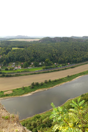 View from the top of the mountain on the river and the villageの写真素材
