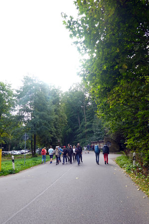 Unidentified people walk along the road in Krakowの写真素材