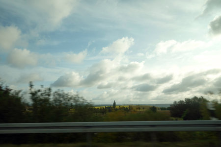 View from the car on the road to the church. Cloudy sky.の写真素材