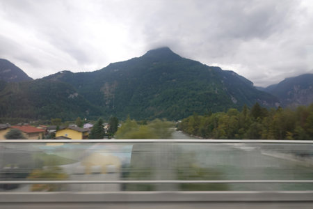 View from the train window to the mountains and the river. Motion blur.の写真素材