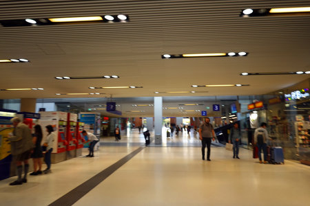 Interior of a modern shopping mall with people walking in motion blurの写真素材