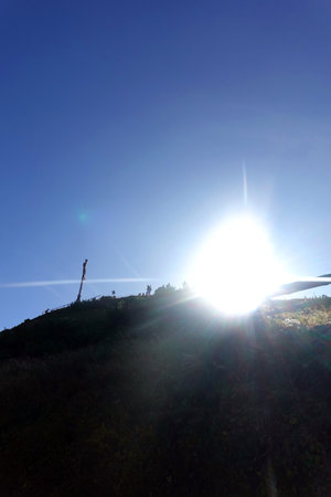 Silhouette of people on the top of the mountain with sunの写真素材