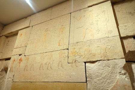 Ancient Egyptian hieroglyphs on the wall, closeup of photo