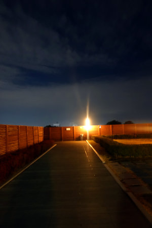 Night view of a road in the countryside in the evening with lightsの写真素材