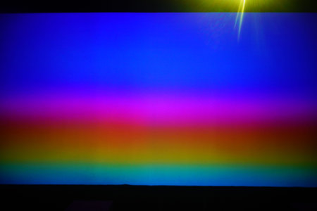colorful background with lights and rays of light on a dark background