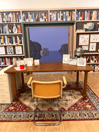 Interior of a library with bookshelf, books and table