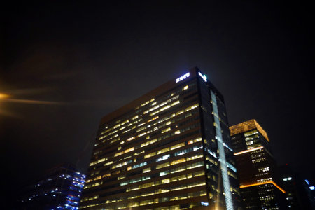 Modern office building at night, closeup photo with shallow depth of field