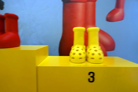 Close up view of children's toys on a yellow wooden stand.の写真素材