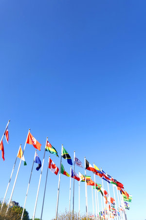 Many flags of different countries waving in the wind, closeup of photo