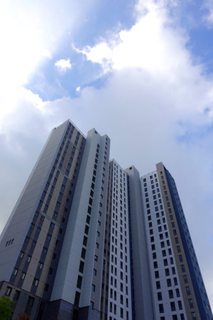 High rise building under blue sky with white cloud, closeup of photo