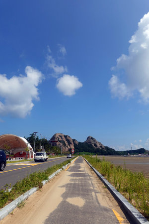 Road to the beach with blue sky and white clouds, Thailand.の写真素材