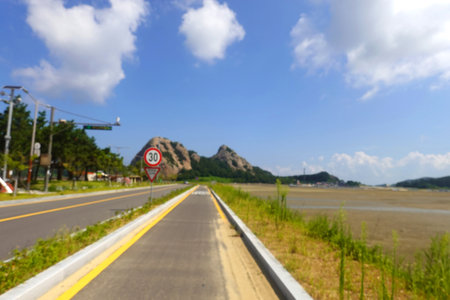 Blur image of road and mountain with blue sky and cloud background.の写真素材