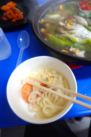 Noodle soup with shrimps and vegetables on the table.の写真素材