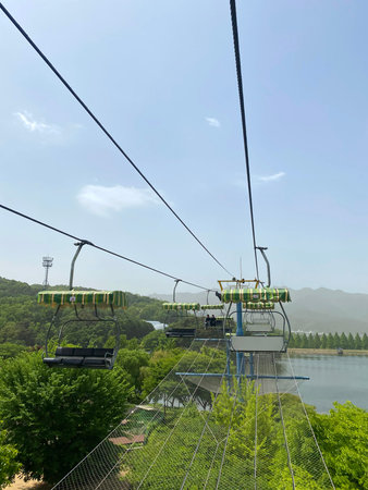Cable car on the background of mountains and blue sky with clouds
