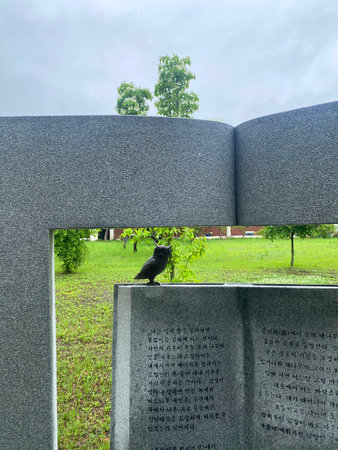 Crow sitting on the grave of the unknown soldier in the cemetery