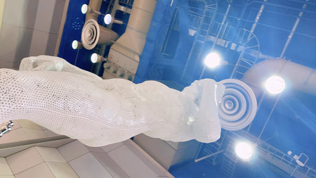 Mannequin hand in white clothes on the background of the night city