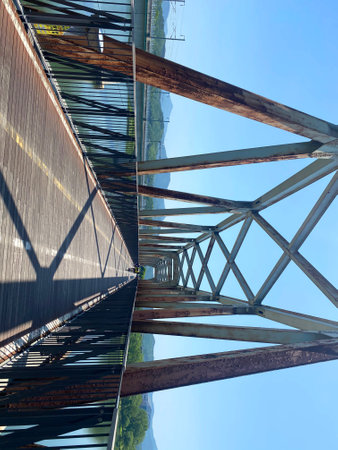 Steel structure of a power line with a blue sky in the backgroundの写真素材