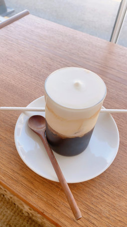 Cappuccino in a cup on a wooden table, stock photo