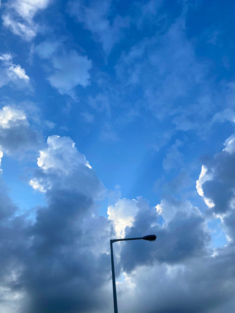 Blue sky with white clouds and street lamp. Nature background. Soft focus.の写真素材