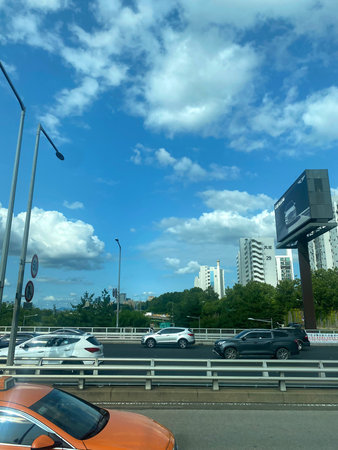 Highway traffic in the city with blue sky and white clouds.の写真素材