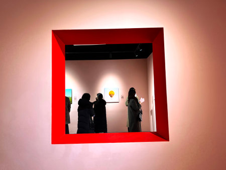 People in a red box looking at the display of a store windowの写真素材