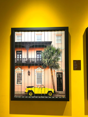 Window with a yellow car on a yellow wall in the center of Lisbon, Portugal