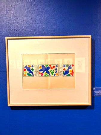 Colorful ceramic tiles on a blue wall in an art gallery.