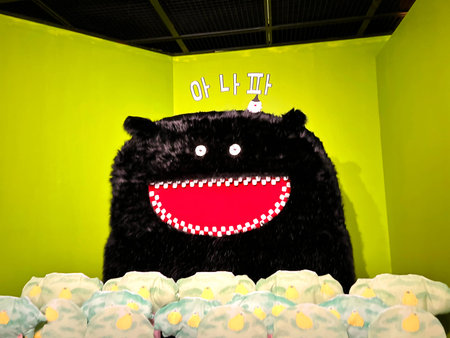 Cute black bear on birthday cake with light bulbs in green room