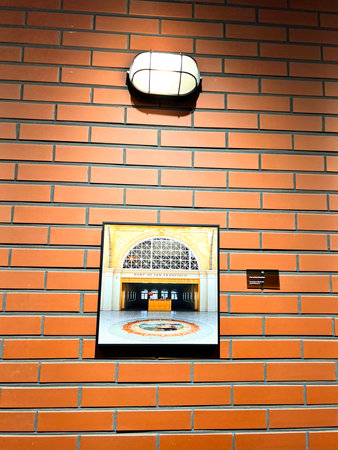 Brick wall with a window with a picture of a concert hall