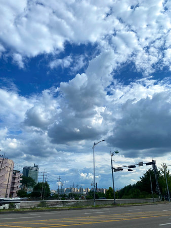 Cloudy blue sky over the road in the city of Seoul, South Koreaの写真素材