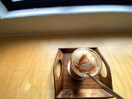 coffee cup with ice cream on the wooden tray in coffee shop