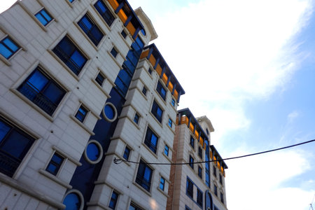Modern apartment buildings on blue sky background. Facade of a modern apartment building