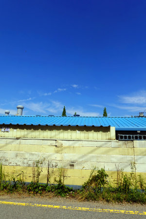 abandoned factory building, closeup of photo with blue sky