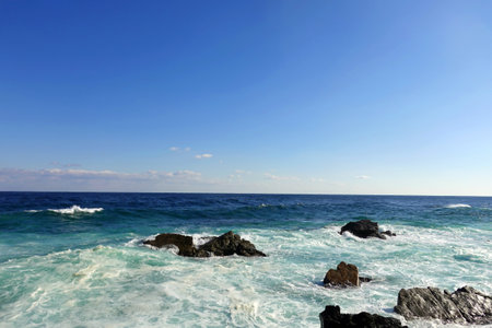 Seascape with blue sky and waves in Okinawa, Japan.の写真素材