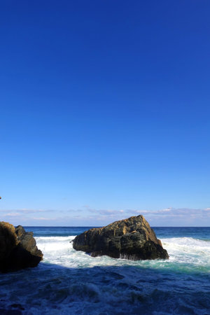 beautiful seascape with blue sky and rocks in the seaの写真素材