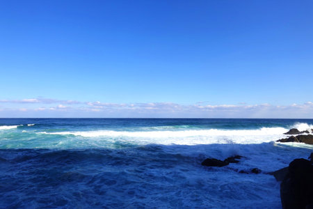 Beautiful seascape with ocean waves and blue sky background.