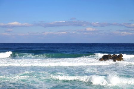 Beautiful seascape with blue sky and waves on the beachの写真素材