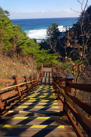 Wooden stairs leading to the sea on the background of the mountains.