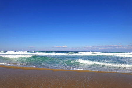 beautiful beach and tropical sea under blue sky, closeup of photoの写真素材