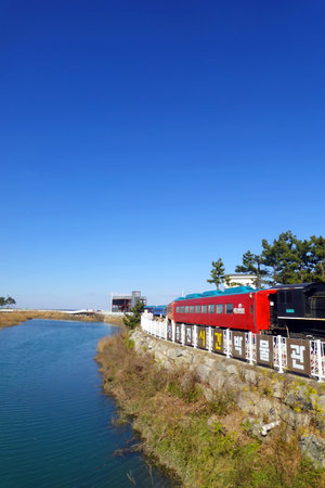 Train on the river under the blue sky, closeup of photo