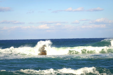 Big wave breaking on a rock in the sea. Big wave breaking on a rock.